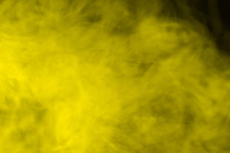 Yellow steam on a black background. Copy space.の写真素材