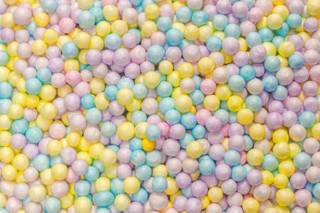 Purple, yellow, blue plastic balls background.