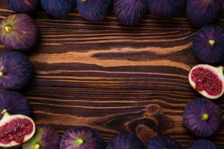 Tasty figs in a bowl on wooden background. Top view. Slices.の写真素材