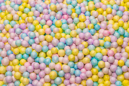 Purple, yellow, blue plastic balls background.の写真素材