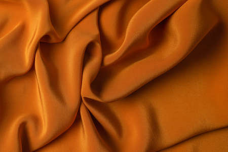 Golden silk or satin luxury fabric texture can use as abstract background. Top view.の写真素材