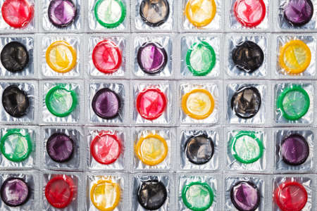 Colorful condoms background. Top view.