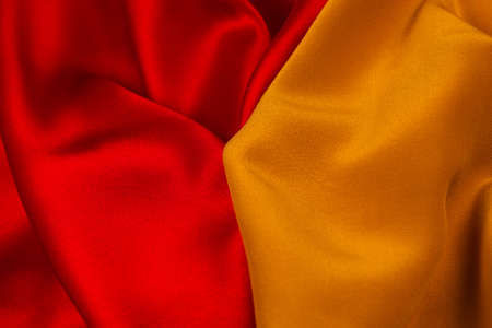 Red and orange silk or satin luxury fabric texture can use as abstract background. Top view.の写真素材