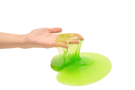 Green slime toy in woman hand isolated on white background.