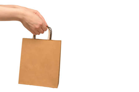 Paper bag in woman hands isolated on white background.の写真素材