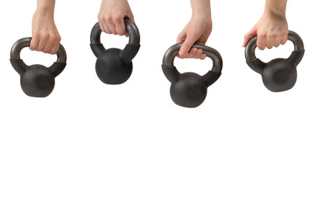 Black weight isolated on white in woman hand. 4 kg weight. Fitness for women.の写真素材