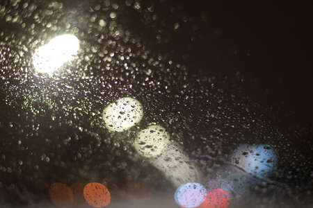 Blurred background with raindrops and lights.