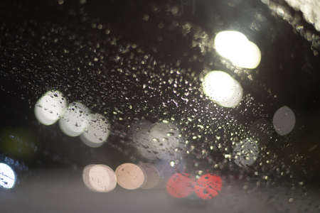 Blurred background with raindrops and lights.の写真素材