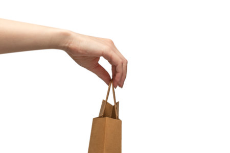 Paper bag in woman hands isolated on white background.の写真素材