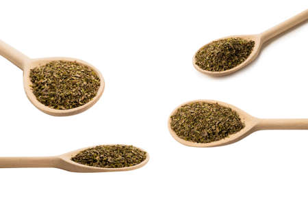 Oregano spice in wooden spoon isolated on white background.
