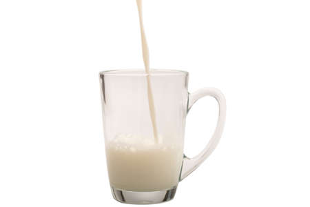 Milk in the cup isolated on white background.の写真素材