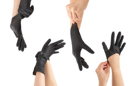 Woman puts on black rubber gloves. Isolated on white.の写真素材