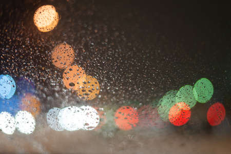 Blurred background with raindrops and lights.の写真素材