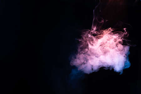 Blue and pink steam on a black background. Copy space.の写真素材