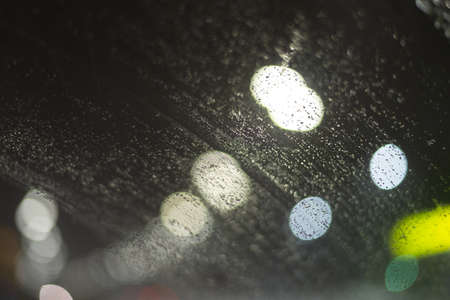 Blurred background with raindrops and lights.