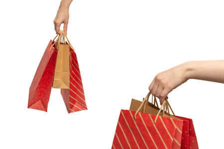 Paper bag in woman hands isolated on white background.の写真素材