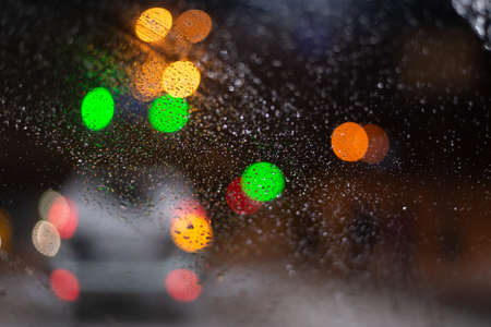 Blurred background with raindrops and lights.