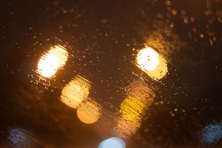 Blurred background with raindrops and lights.
