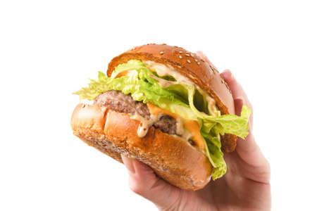 Hamburger in woman hands isolated on a white background. Top view.