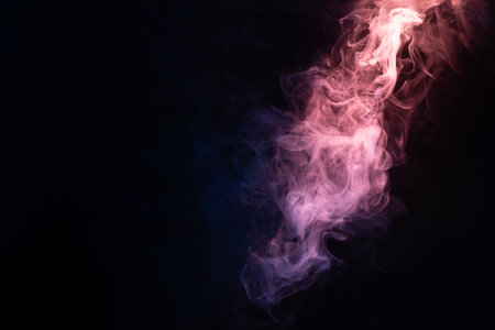 Blue and pink steam on a black background. Copy space.の写真素材