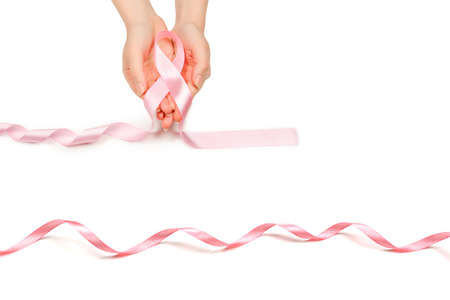 Pink ribbon in woman hands isolated on white. Breast Cancer Awareness ribbon.
