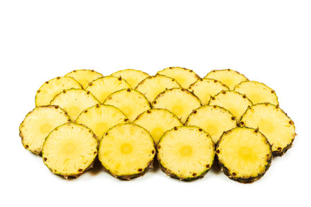 Pineapple juicy yellow slices background. Top view.の写真素材