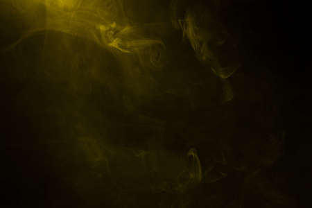 Yellow and pink steam on a black background. Copy space.の写真素材