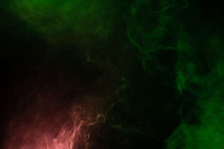 Green and pink steam on a black background. Copy space.の写真素材