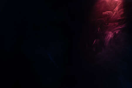 Blue and pink steam on a black background. Copy space.