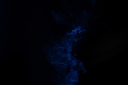Blue and pink steam on a black background. Copy space.の写真素材