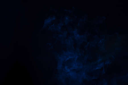 Blue and pink steam on a black background. Copy space.の写真素材