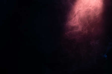 Blue and pink steam on a black background. Copy space.の写真素材