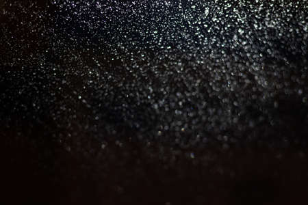 Blurred background with raindrops and lights.