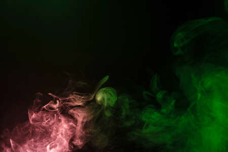 Green and pink steam on a black background. Copy space.の写真素材
