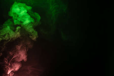 Green and pink steam on a black background. Copy space.の写真素材