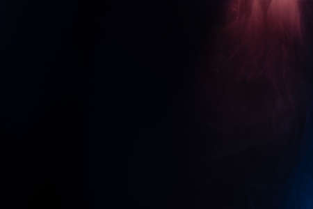 Blue and pink steam on a black background. Copy space.の写真素材