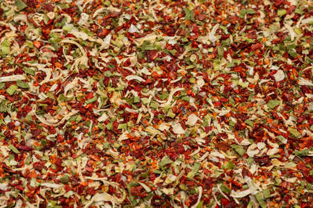 Seasoning for soup, dried vegetables slices background. Top view.