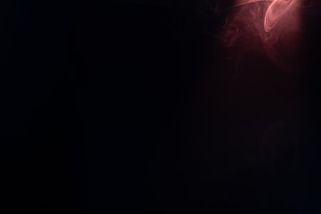 Blue and pink steam on a black background. Copy space.の写真素材