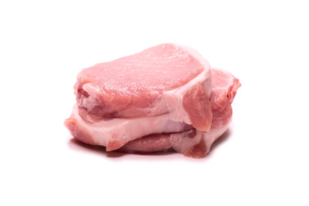 Raw pork pieces isolated on a white background. Top view.の写真素材