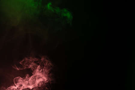 Green and pink steam on a black background. Copy space.