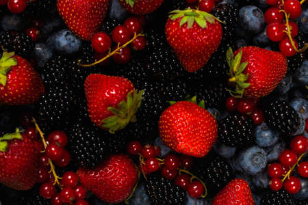 Blackberry, raspberry, blueberry, red currant as a background. Top view.