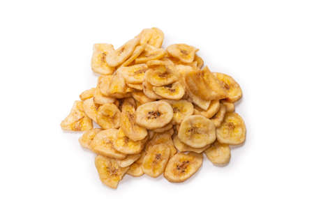 Banana chips isolated on a white background. Dehydrated banana slices.の写真素材
