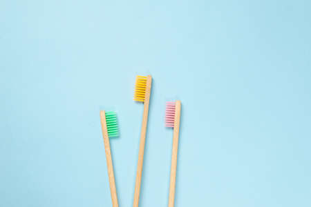 Bamboo toothbrush on a blue background. Top view.の写真素材
