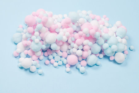 White, pink and blue soft pompons as a background. Bright background.の写真素材