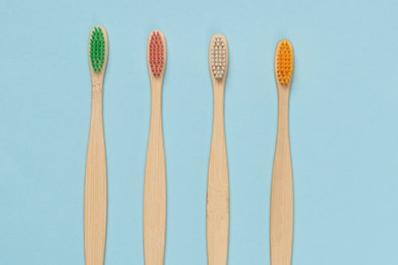 Bamboo toothbrush on a blue background. Top view.の写真素材