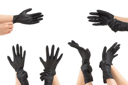 Woman puts on black rubber gloves. Isolated on white.の写真素材