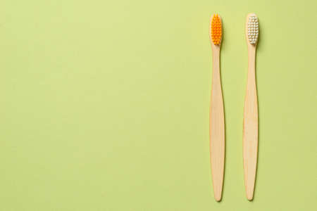 Bamboo toothbrush on a green background. Top view.の写真素材