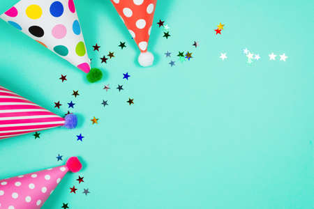 Colorful birthday caps on a blue background. Top view. Copy space.の写真素材
