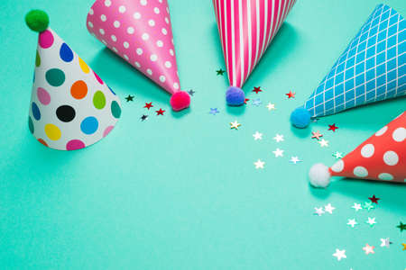 Colorful birthday caps on a blue background. Top view. Copy space.の写真素材