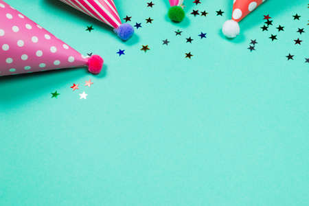 Colorful birthday caps on a blue background. Top view. Copy space.の写真素材